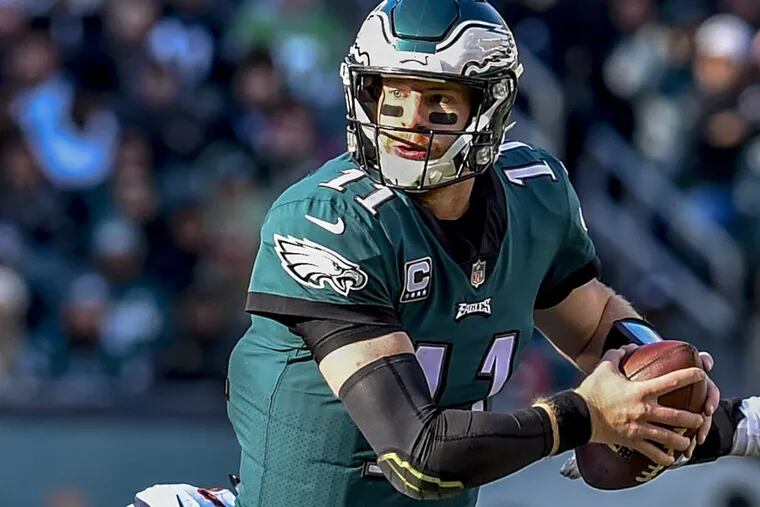 Eagles quarterback Carson Wentz is tackled after scrambling during the Eagles 31-3 win over the Bears November 26, 2017 at Lincoln Financial Field.
