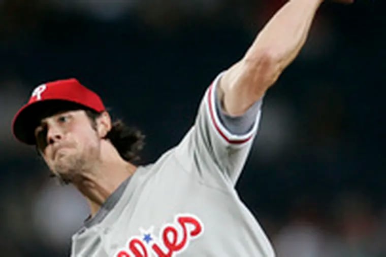 The Phillies&#0039; Cole Hamels pitches to the Braves&#0039; Chris Woodward in the fourth inning. In the first inning, Atlanta jumped all over Hamels for three runs on five hits. The Phils came right back in the second with four runs.