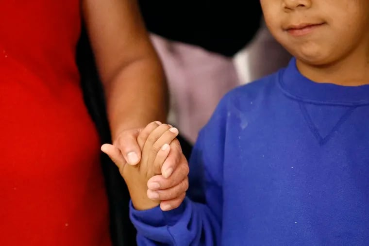 Darwin Micheal Mejia, right, holds hands with his mother, Beata Mariana de Jesus Mejia-Mejia, following their reunion at Baltimore-Washington International Thurgood Marshall Airport. The Justice Department agreed to release Mejia-Mejia's son after she sued the U.S. government in order to be reunited following their separation at the U.S. border.