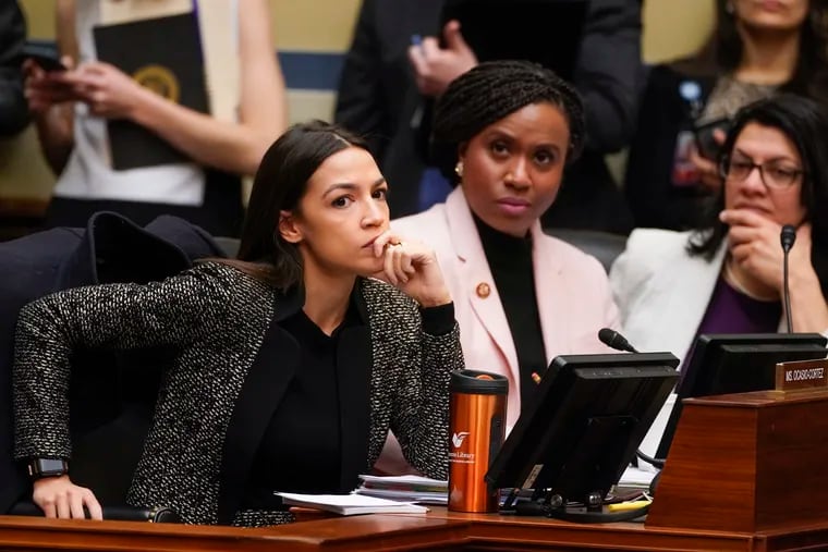 U.S. Rep. Alexandria Ocasio-Cortez, D-N.Y., left, sitting among fellow members of the House Oversight and Reform Committee.