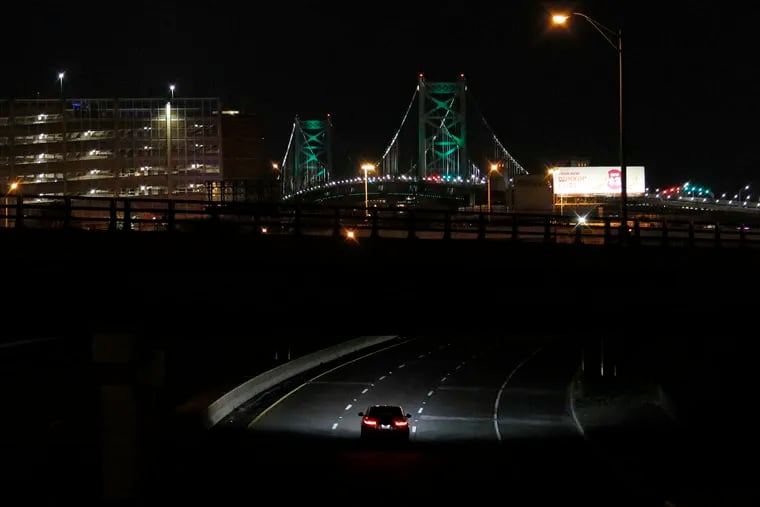 A single car heads westbound on Route 30 toward the Ben Franklin Bridge in New Jersey just after 9 p.m. Gov. Phil Murphy earlier ordered all non-essential businesses to close to banned all public gatherings.