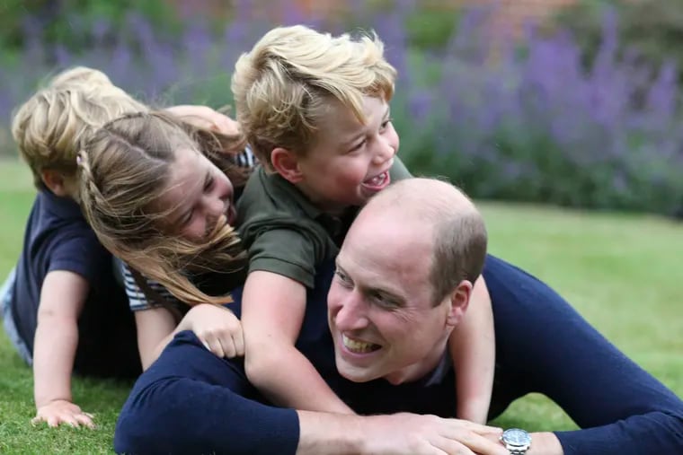 This undated photo released by Kensington Palace, which was taken by the Duchess of Cambridge, shows Prince William, the Duke of Cambridge, with his children Prince George, Princess Charlotte and Prince Louis, left, in a photo marking both his birthday and Father's Day.