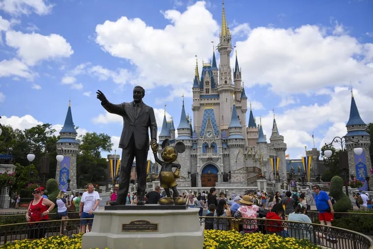 The "Partners" statue, depicting Walt Disney and Mickey Mouse, sits in front of Cinderella's Castle at Magic Kingdom in Disney World.