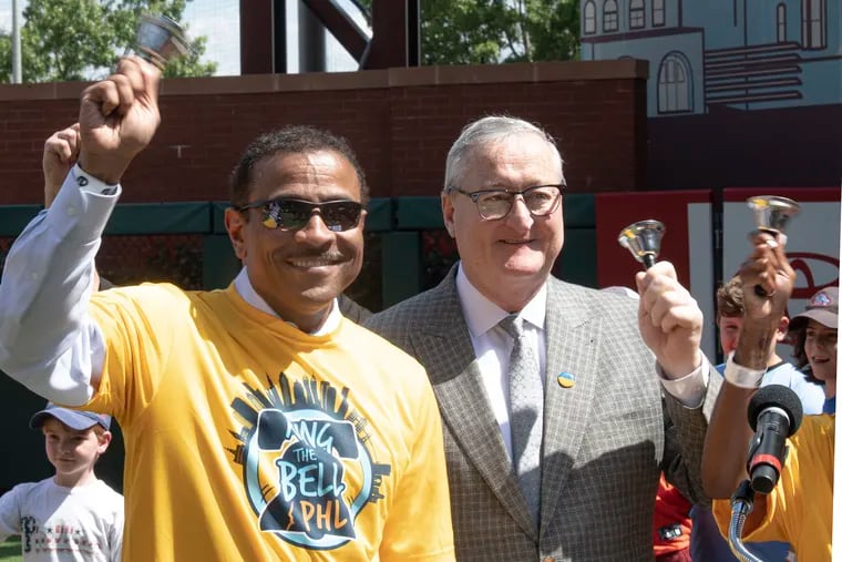 Philadelphia Superintendent Tony Watlington, left, and Mayor Jim Kenney ring bells during a back-to-school event held at Citizens Bank Park on Wednesday.