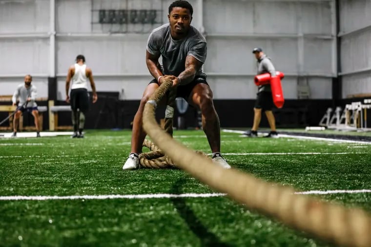 Philadelphia Eagles running back Kenneth Gainwell works out inside of the indoor practice facility at UCF with trainer Bert Whigham, background right, on Monday, March 14, 2022 in Orlando, Fl. Gainwell was working out with Whigham and other NFL players which were former UCF football players