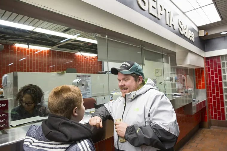 Philadelphia Eagles fans, Jeremy Fuller and his son Jeremy Jr. from Thorndale, Pennsylvania, buy their regional rail tickets for Thursday’s Super Bowl Parade at Jefferson Station in Philadelphia on Wednesday morning February 7, 2018. The Fuller’s left their house this morning at 4 a.m., stopping at 3 other locations before scoring rail tickets at Jefferson Station.
