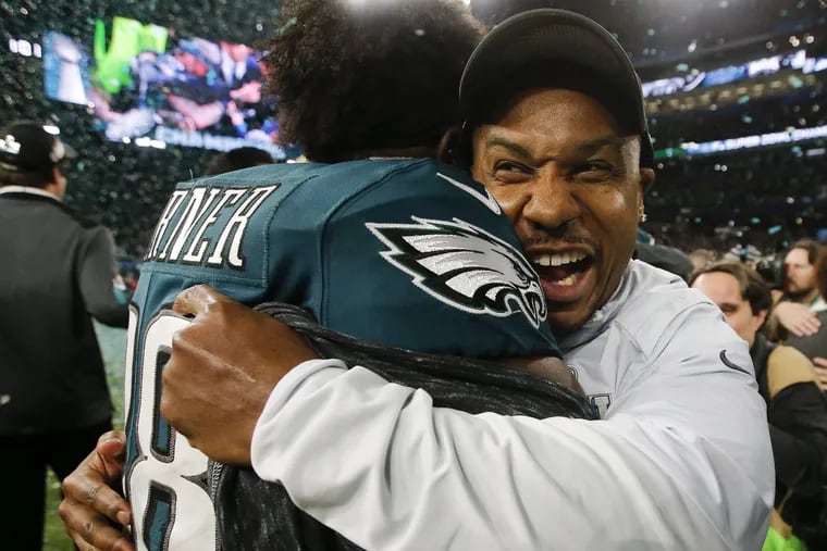 Eagles running back Darren Sproles celebrates with teammate running back Kenjon Barner after the Eagles beat the New England Patriots in Super Bowl LII on Sunday, February 4, 2018 in Minneapolis. YONG KIM / Staff Photographer