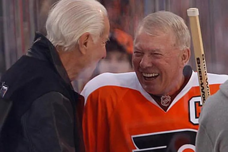 Bob Clarke shares a laugh with Ed Snider during the Winter Classic Alumni game. (Ron Cortes/Staff Photographer)