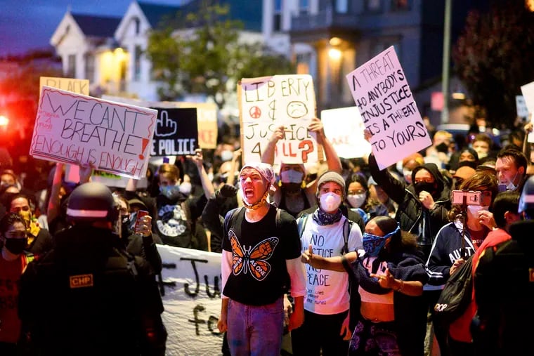 Demonstrators faced off against police officers in Oakland, Calif. Friday night while protesting the Monday death of George Floyd, a handcuffed black man in police custody in Minneapolis.