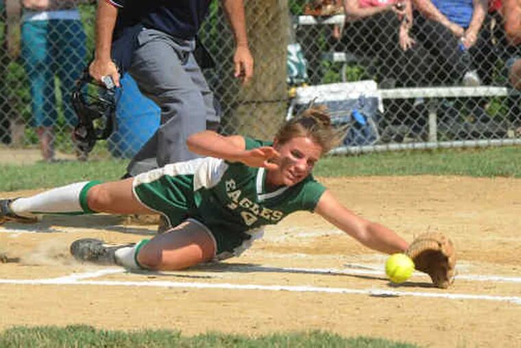 Bishop Shanahan pitcher Kate Poppe dives for the ball, but can't stop Hatboro-Horsham from scoring.