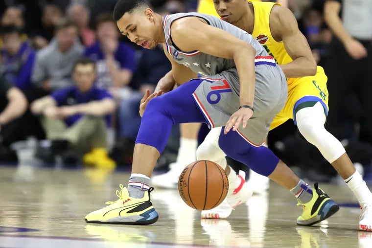 Zhaire Smith, left, of the Sixers has the ball knocked away by Tim Frazier of the Bucks at Wells Fargo Center during the 1st half on April 4, 2019.