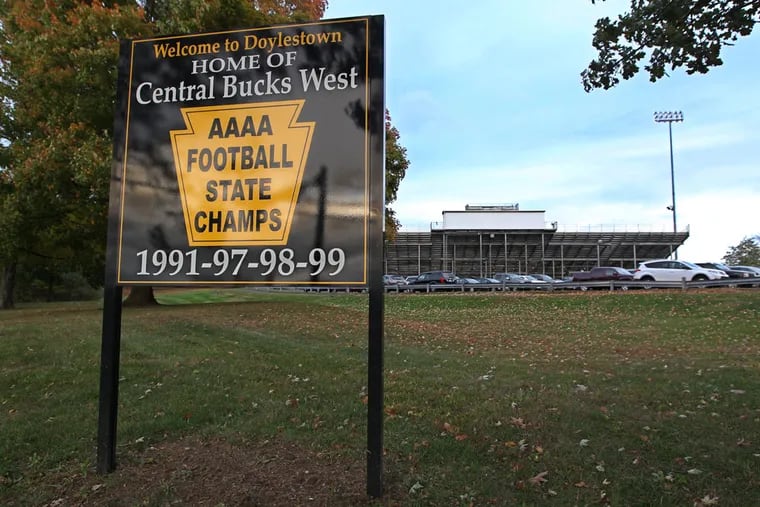 A sign in front of the Central Bucks West stadium heralds the football team's state championships.