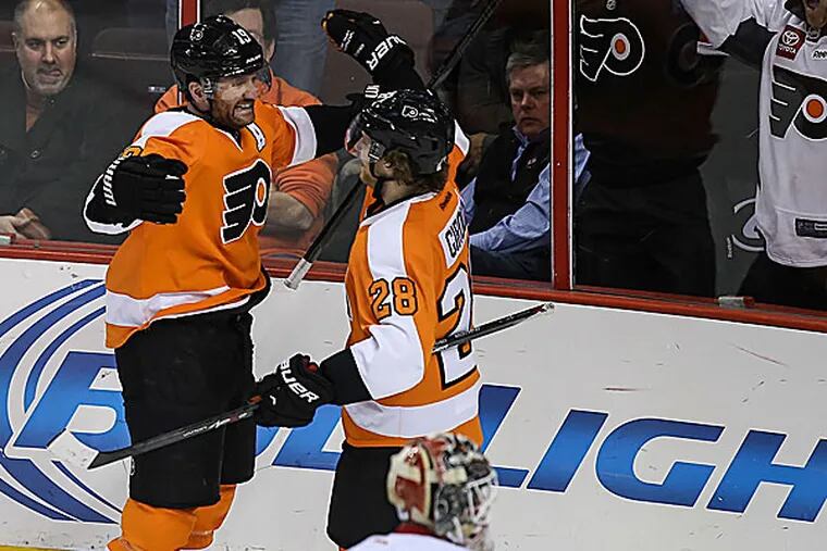 The Flyers' Scott Hartnell and Claude Giroux celebrate a goal against the Red Wings. (Steven M. Falk/Staff Photographer)