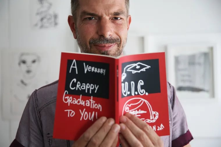 Artist Joe Ovelman stands for a portrait with his book "You I See" in his home studio in North Philadelphia. "You I See" is about the student loan crisis.