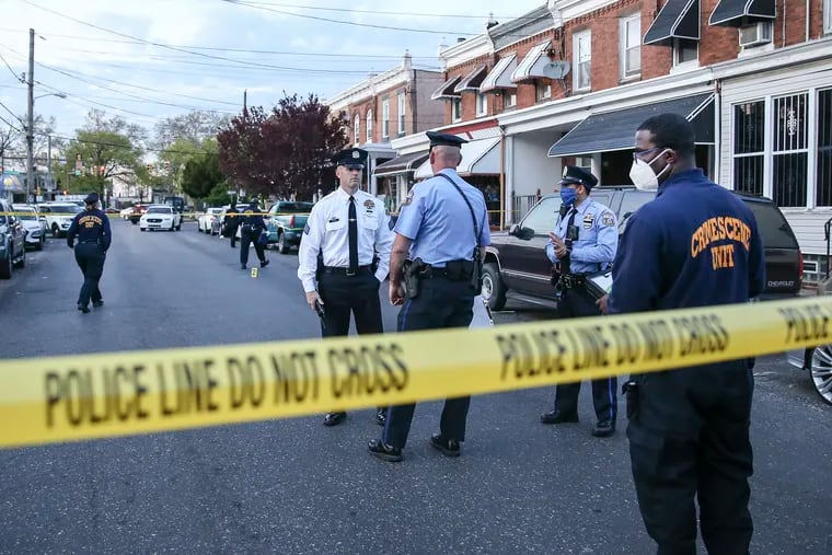 Philadelphia Police investigate the fatal shootings of two men in the 4700 block of North Third Street in Feltonville on Tuesday.