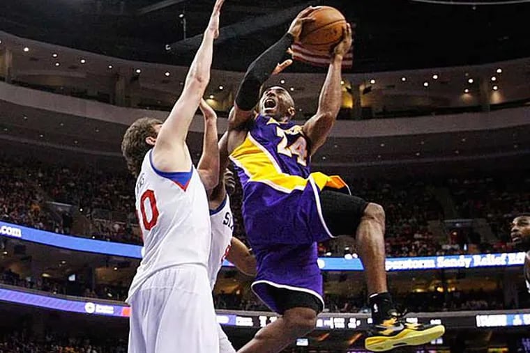 Kobe Bryant scores two of his 34 points over Spencer Hawes. (Ron Cortes/Staff Photographer)