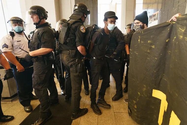 Police arrest a protester at the Municipal Services Building in Philadelphia, June 23, 2020.