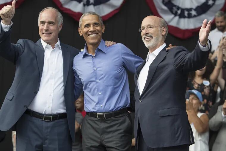President Barack Obama, center, attended a rally for Senator Bob Casey, left, and Governor Tom Wolf, right, and Pennsylvania democrats at The Dell on Sept. 21, 2018. CHARLES FOX / Staff Photographer