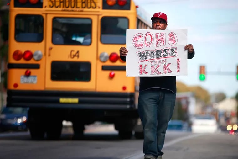 Ron Suber stands in the middle East Lincoln Highway protesting Richard Como, the superintendent, and Jim Donato, director of athletics at the Coatesville Senior High School, on Monday. DAVID SWANSON / Staff Photographer