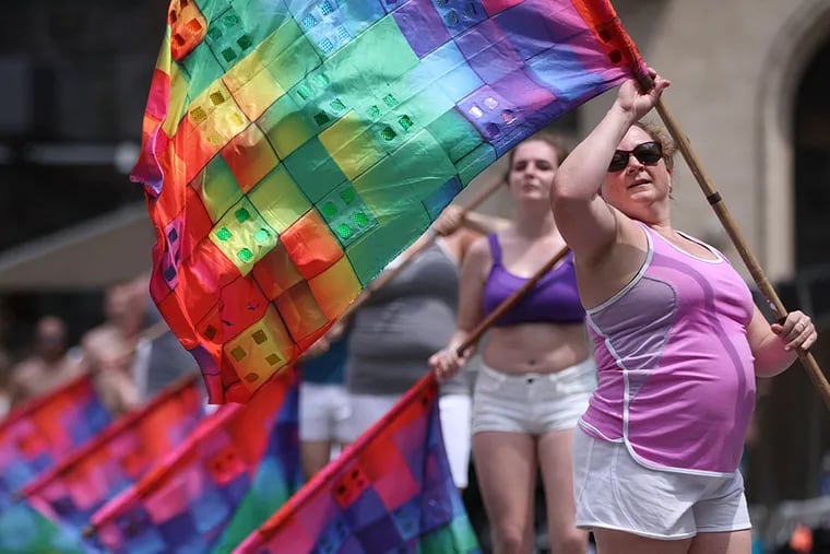 Members of the Flaggots perform their rainbow flag routine for the LGBT Pride parade on Sunday.  LGBT Pride parade and festival gets underway in the Gayborhood, winding past a judges' stand at 6th and Market Streets and a festival at the Great Plaza at Penn's Landing. MICHAEL BRYANT / Staff Photographer