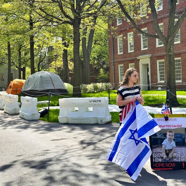 Rotem Spiegler, an alumni of Harvard University, stands near an encampment set up at the university to protest the war in Gaza on Tuesday in Cambridge, Mass. The encampment was being voluntarily removed early Tuesday.