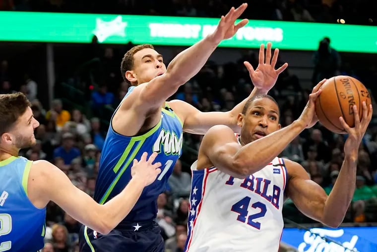The Dallas Mavericks' Dwight Powell (7) defends against the Sixers' Al Horford (42) during the first half at American Airlines Center on Saturday.