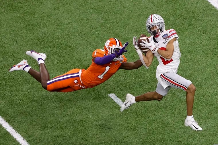Ohio State wide receiver Chris Olave catches a touchdown pass in front of Clemson cornerback Derion Kendrick.