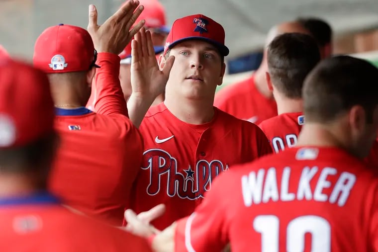 Phillies pitcher Spencer Howard high-fives his teammates after pitching the eighth inning against the Minnesota Twins in a spring training game in Clearwater, Fla.