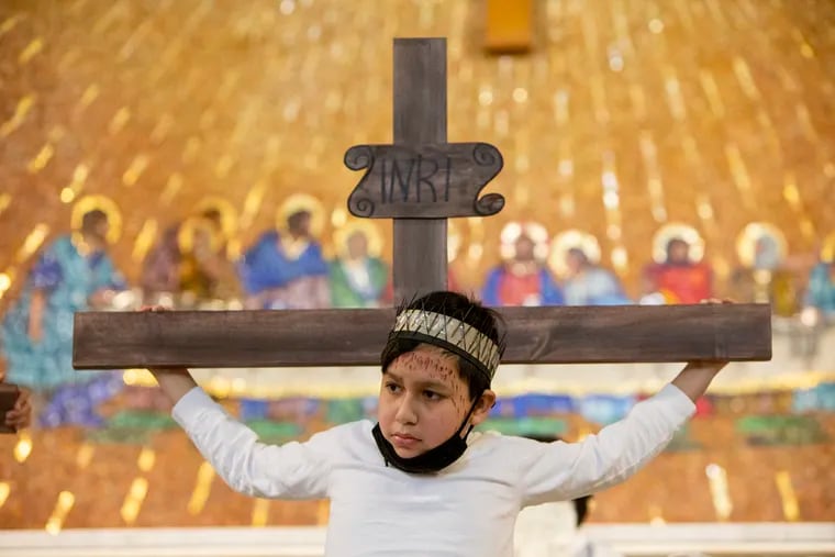 Jesus played by Bryan Aguilar Acosta, 12, is nailed to the cross. Children from the Annunciation BVM Church, Formacion Cristiana, Christian Formation program for children  reenacted this day on Good Friday, April 2, 2021.
