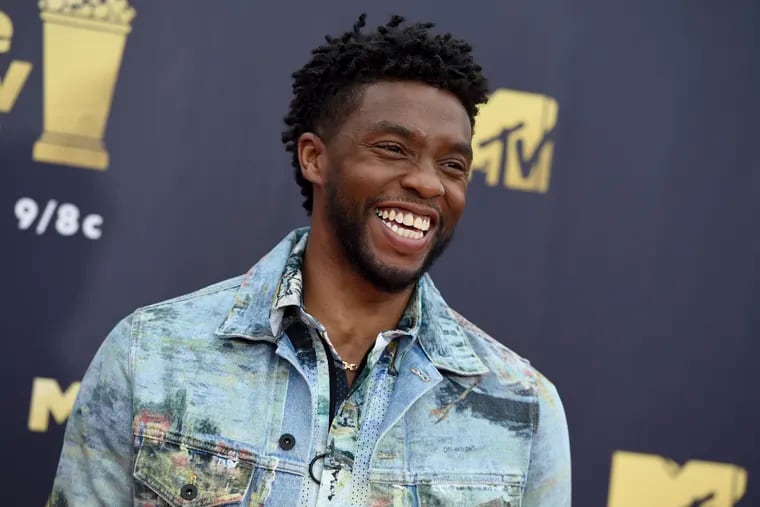 In this Saturday, June 16, 2018 file photo, Chadwick Boseman arrives at the MTV Movie and TV Awards at the Barker Hangar in Santa Monica, Calif.  Actor Chadwick Boseman, who played Black icons Jackie Robinson and James Brown before finding fame as the regal Black Panther in the Marvel cinematic universe, has died of cancer. His representative says Boseman died Friday, Aug. 28, 2020 in Los Angeles after a four-year battle with colon cancer. He was 43.