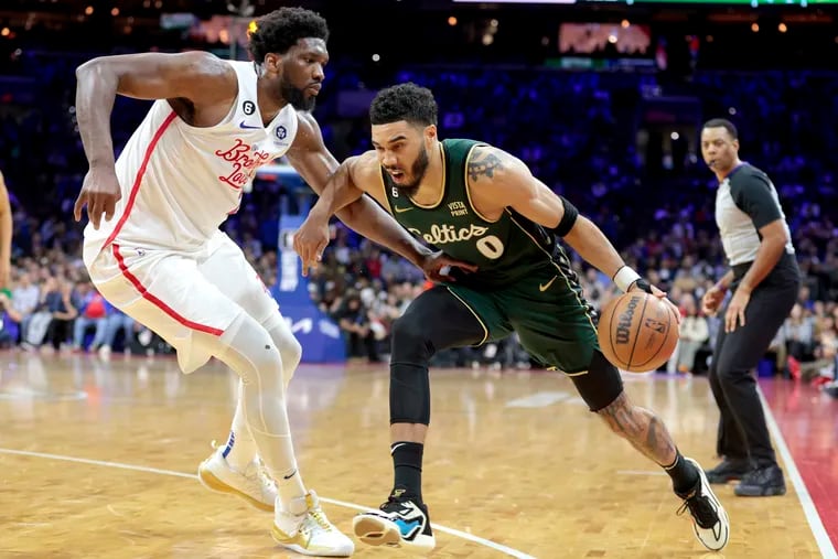 Joel Embiid, (left) of the Sixers tries to defend Jayson Tatum of the Celtics during the 2nd half of their game at the Wells Fargo Center on Feb. 25, 2023.