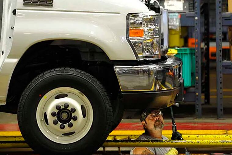 In this Aug. 12, 2015 photo, a worker works on the production line at Ford Motor Company’s Ohio Assembly Plant in Avon Lake, Ohio. Major automakers report sales figures for August on Tuesday, Sept. 1, 2015. (AP Photo/David Richard)
