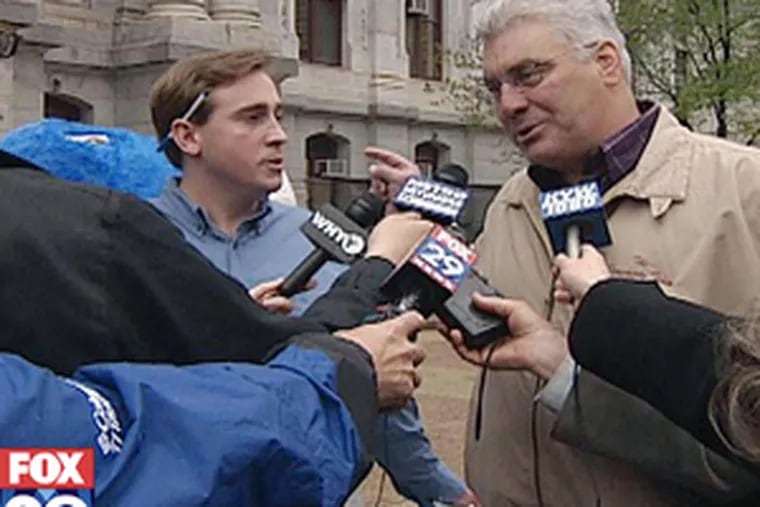 Jim Nixon (left), sidekick of Tom Knox-taunting figure Tommy the Loan Shark, is confronted by publicist Frank Keel (right), who asserted that mayoral candidate Bob Brady is behind it all.