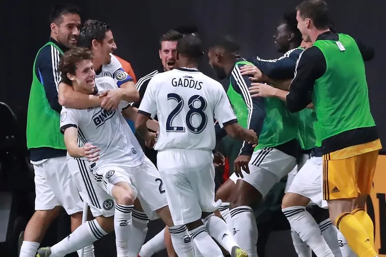 Alejandro Bedoya embraces Brenden Aaronson as Union players celebrate with the 18-year-old Medford native after he scored his first goal for the team.
