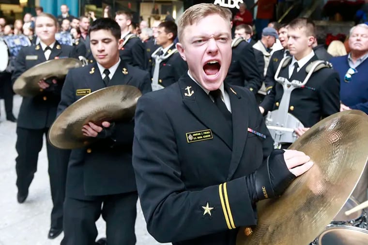 DAVID SWANSON / STAFF PHOTOGRAPHER Navy Midshipman Jonathan French mans the cymbals during the big pep rally.