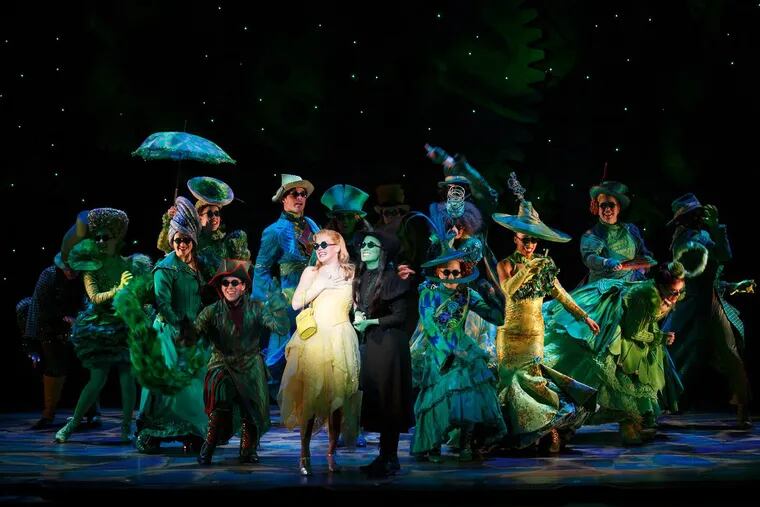 Ginna Claire Mason (center in white) and Jessica Vosk (center in black) lead the cast in ‘Wicked,’ at the Academy of Music through Aug. 27.