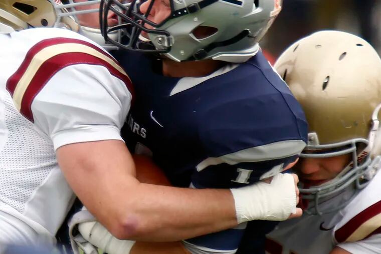 Haverford School's Mickey Kober (left) and Colin Hurlbrink tackle Malvern Prep's Mike Fay. Haverford won Saturday's Inter-Ac game, 31-14.