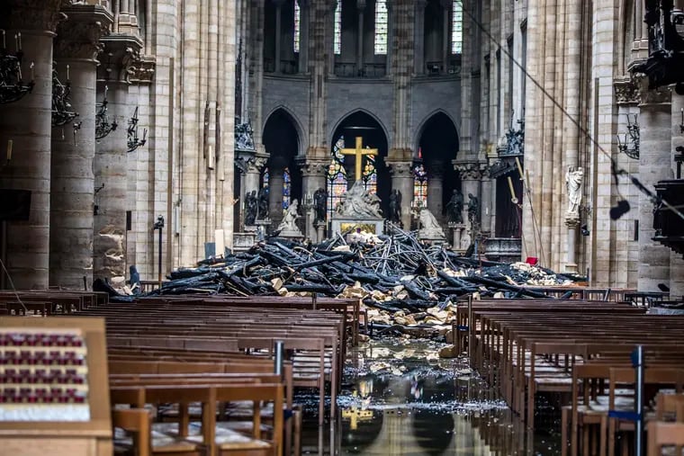 debris are seen inside the damaged Notre Dame cathedral in Paris, Tuesday, April 16, 2019. Firefighters declared success Tuesday in a more than 12-hour battle to extinguish an inferno engulfing Paris' iconic Notre Dame cathedral that claimed its spire and roof, but spared its bell towers and the purported Crown of Christ. (Christophe Petit Tesson, Pool via AP)