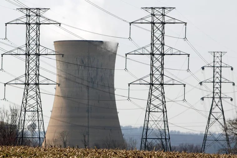 A cooling tower of the Three Mile Island nuclear power plant forms a backdrop for power lines in Middletown, Pa. At issue, says a PUC spokesman, is how to maintain a safe energy infrastructure while encouraging efficiency and conservation.