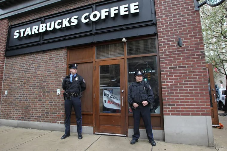 Police stand outside the Starbucks at 18th and Spruce Streets in Philadelphia. After two black men were arrested there, information about a similar incident that happened in California in January is also coming to light.