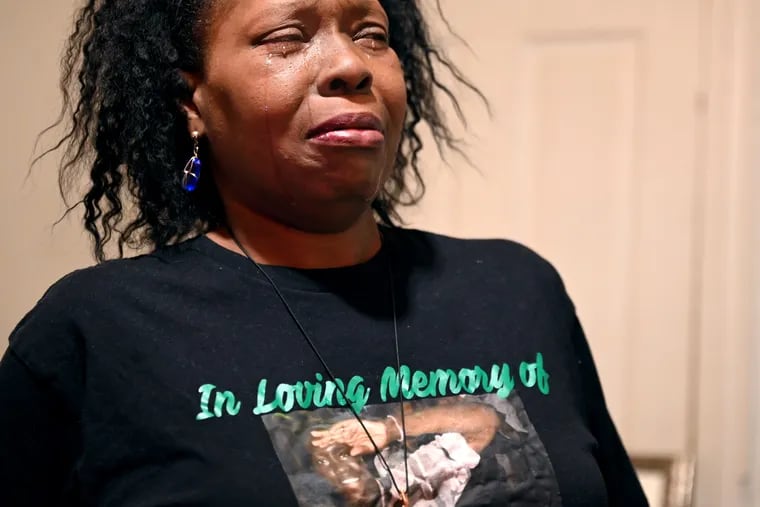 Tysha Melton cries as she visits a memorial to her late son, Travys Taylor, in his old room in her home in an April 11, 2022 file photo.