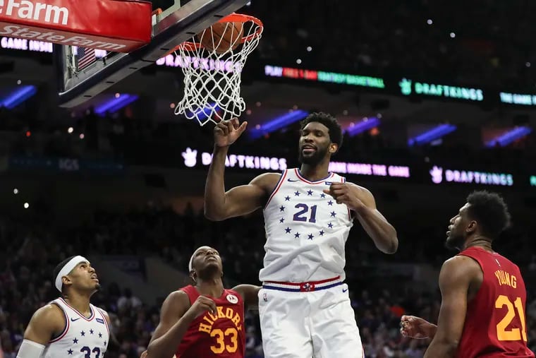 Joel Embiid tips in a basket in the fourth quarter of the Sixers' win over the Pacers on Sunday at the Wells Fargo Center.