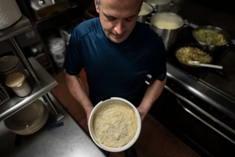 Steve Stetzler shows a potato filling dish before it goes in the oven at the Deitsch Eck Restaurant in Lenhartsville, Pa. Thursday, November 7, 2019.
