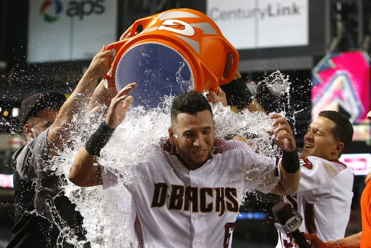 The Diamondbacks' David Peralta gets showered after hitting a walkoff home run in the 14th inning to beat the Phillies in Phoenix.
