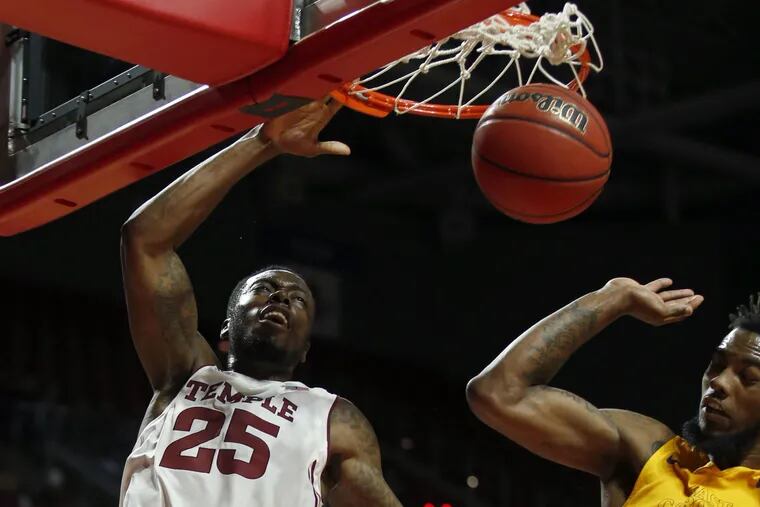 Temple's Quenton DeCosey dunks the basketball past East Carolina's Clarence Williams during the second-half.