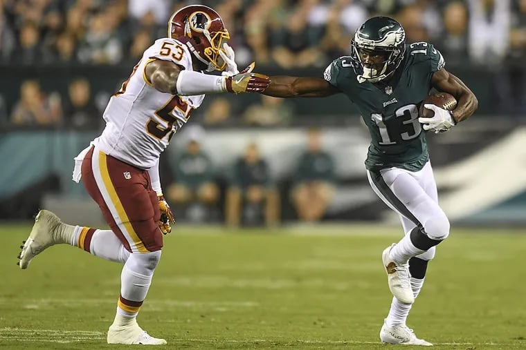 Eagles wide receiver Nelson Agholor stiff arms Washington linebacker Zach Brown.