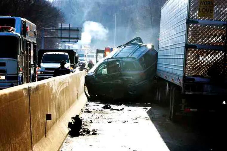 Officials investigate the accident at the Conshohocken Curve. Montgomery County's district attorney called the 18-wheeler "a 74,000-pound death machine."