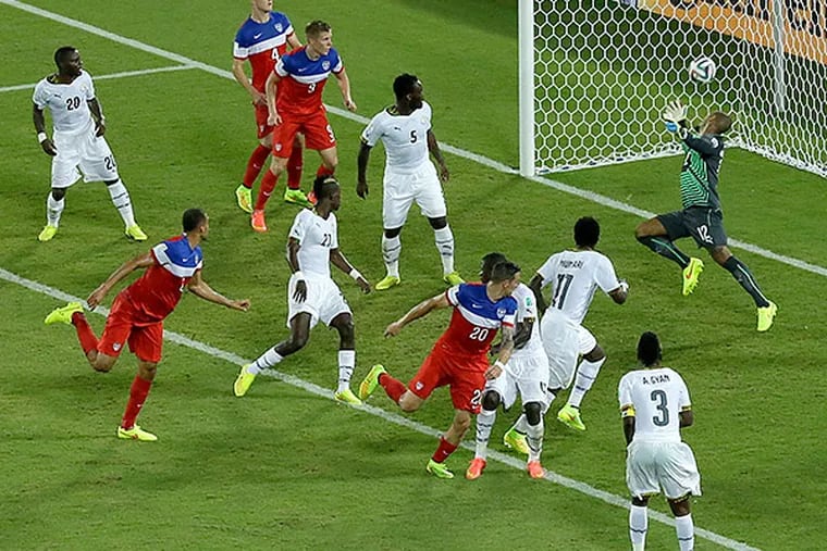 John Brooks watches his header bounce into the net for the United States' game-winning goal against Ghana. (Hassan Ammar/AP)