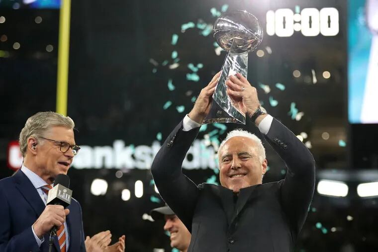 Eagles owner Jeffrey Lurie hoists up the Lombardi trophy after Super Bowl LII, at U.S. Bank Stadium in Minneapolis, Minnesota, Sunday, Feb. 4, 2018. The Eagles won 41-33. TIM TAI / Staff Photographer