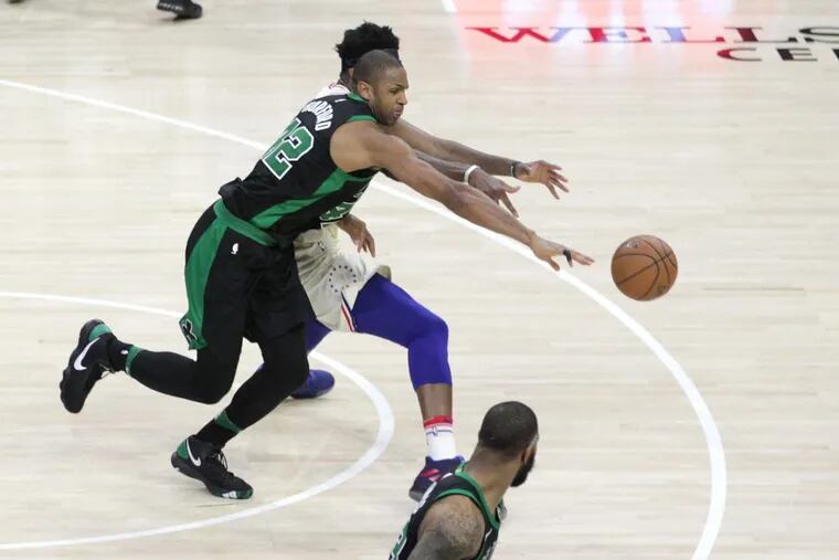 Al Horford (left) of the Celtics steals a Ben Simmons pass intended for Joel Embiid during overtime of Game 3.